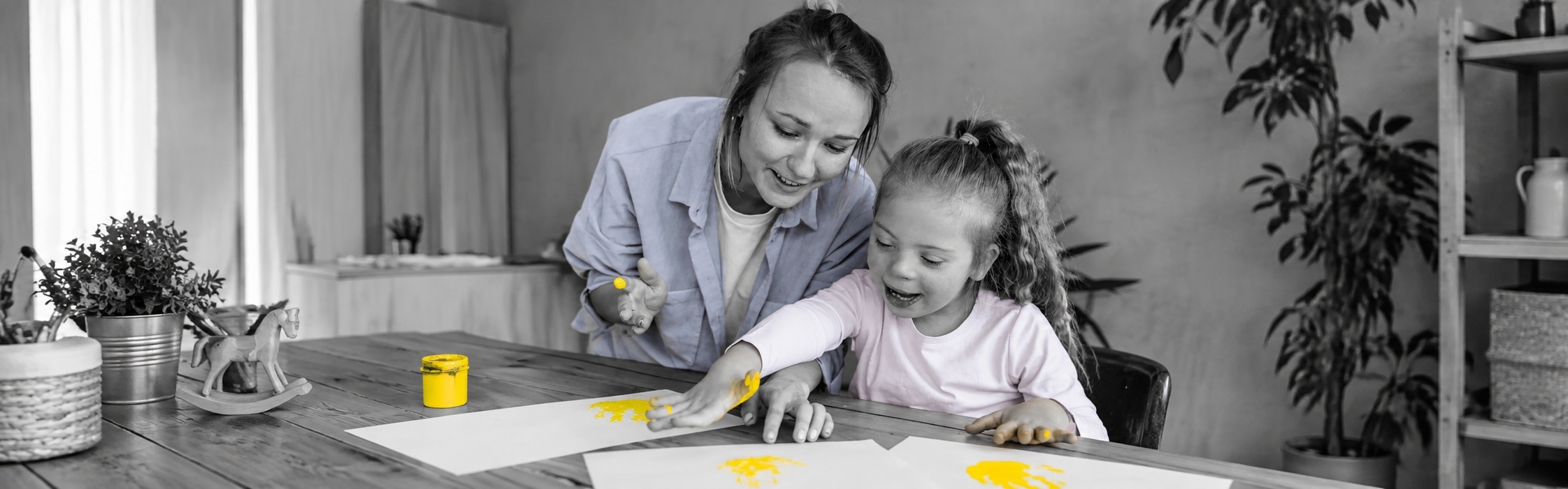 Support worker doing a hand-painting activity with a girl, part of NDIS psychosocial disability support at Global Rehabilitation Service