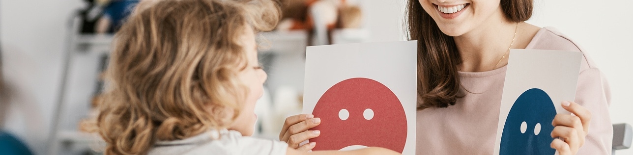 Psychologist using emotion cards with a client during a psychology session at Global Rehabilitation Service